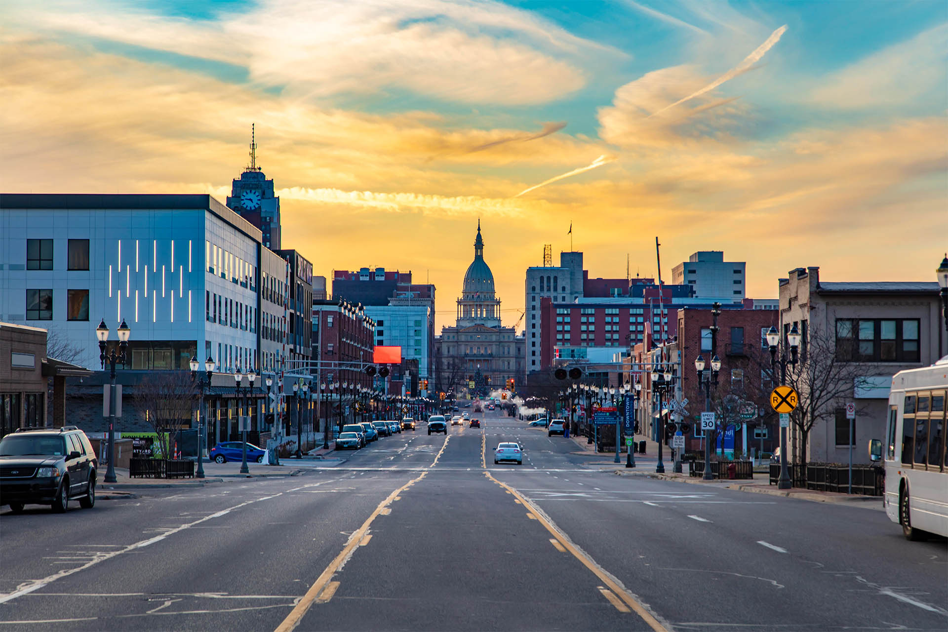 A view of the Michigan state capitol building from the middle of the road in downtown Lansing Michigan.